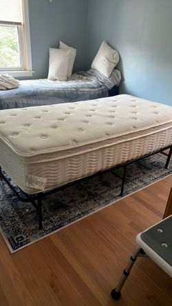 Twin mattress with black metal folding frame