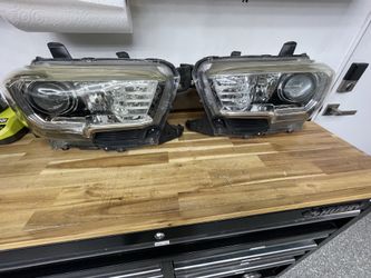 (2) Tacoma front headlights housing off a 3rd Gen Tacoma.  Used Condition and has fading.