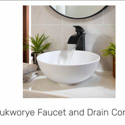 “Modern bathroom faucet with sink and drain included. Sleek black faucet with a white vessel sink,.