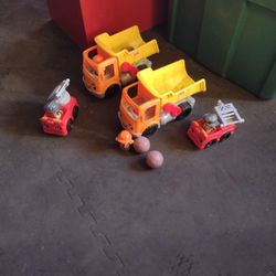 2 Fisher-Price Dump Trucks And Two Fisher-Price Fire Trucks