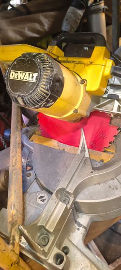 sliding compound miter saw with a red blade installed.