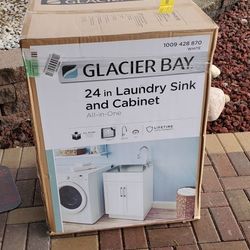 never used Glacier Bay 24 inch laundry sink and cabinet with faucet