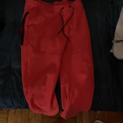 red nike tech pants size m