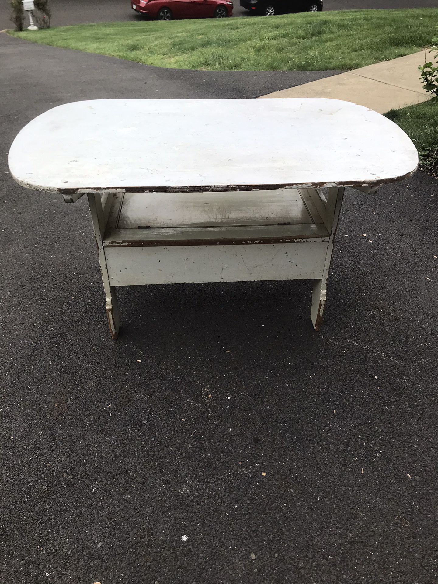 Antique rustic wooden tilt-top table with storage compartment. 