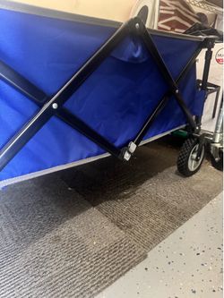 standard collapsible folding utility wagon in good condition with large wheels.