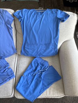 Ceil blue scrubs (6) and 1 under shirt Size XS/S