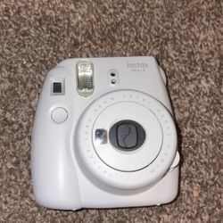 Fujifilm White Instax mini 9 polaroid camera.