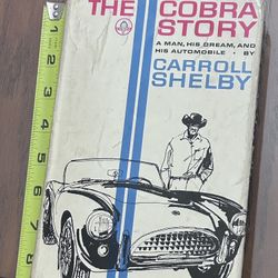 Carroll Shelby signed 1965 Cobra Story book AND rare Cobra English key fob!
