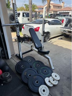 Bench press/squat rack with 228lbs of bumper rubber weights and 7ft 45lbs bar