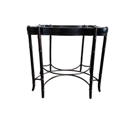 Dark mahogany MCM end table featuring eight faux bamboo legs, iron cross stretcher base, scalloped frame and beveled glass top.