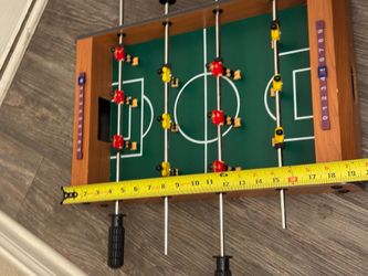 Mini tabletop foosball game, perfect for kids and small spaces.