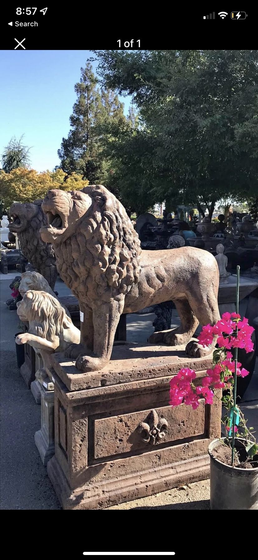 Concrete lion statue with pedestal