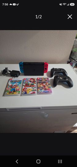 NINTENDO SWITCH, 2 CONTROLLERS, AND 3 GAMES.