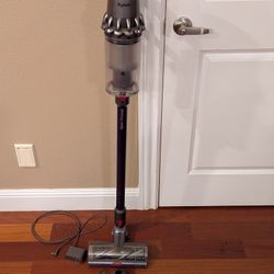 Dyson V11 cordless vacuum with charger and attachments