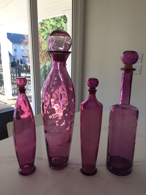 Four decorative colored glass bottles