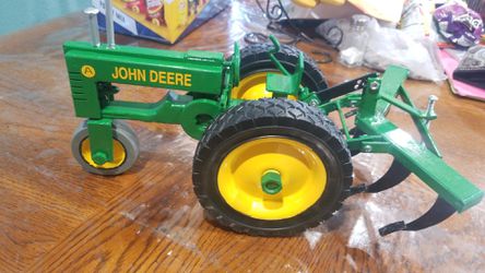 John Deere metal tractor with tool