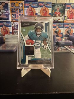 2025 Panini Absolute - Absolute Rookie Materials Travis Hunter #ARM-36 (MEM, RC)