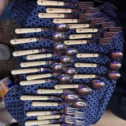 featuring stainless steel utensils with distinctive butterscotch-yellow or ivory plastic handles.  Items: Includes   $45.00