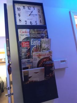 NEW ( NO BOX) STEEL DAR BROWN WALL CLOCK WITH MAGAZINE OR FOLDER RACK.....SIZE 43X14X2 RETAILS FOR 129.95 PLUS TAX ........PRICE IS FIRM