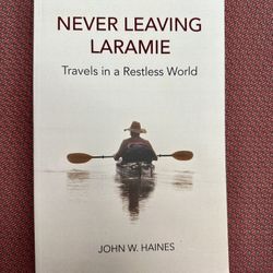New! NEVER LEAVING LARAMIE: Travels in a Restless…(PB, 2020) by John W. Haines