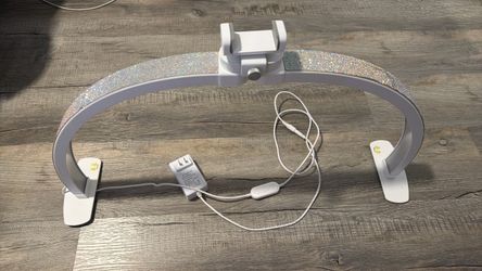 •	Set of 2 LED nail lamps 	•	Elegant silver rhinestone design 	•	Adjustable positioning 	•	White base and frame 	•	Includes power adapters 	•	Ideal fo