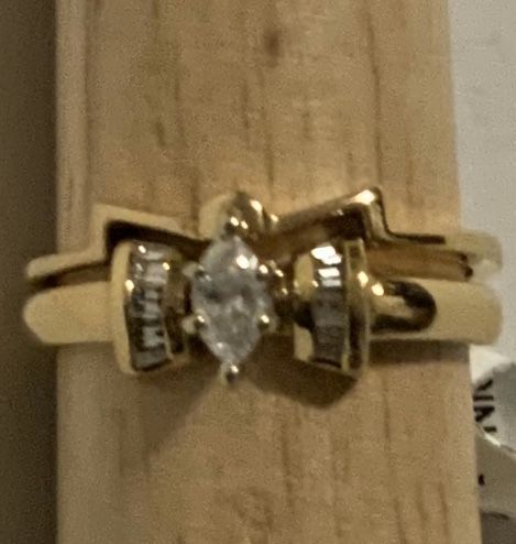 14 karat yellow gold diamond marquise ring with baguette accents and with a bowtie look