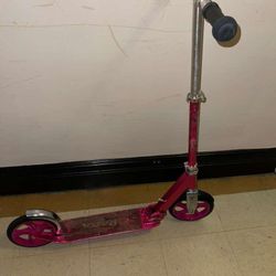 The image shows a pink Razor A5 Lux Kick Scooter. This model is known for its features designed for a smooth ride and its sturdy, foldable aluminum fr