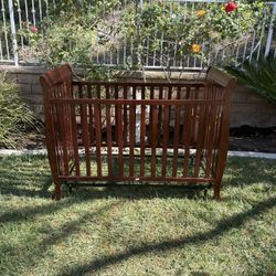 Dark wood baby crib