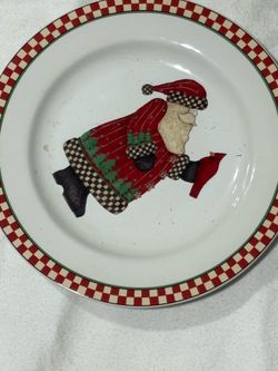 This is a Sakura Debbie Mumm Magic of Santa salad plate featuring a red and white checkered border.