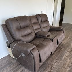 Reclining leather couch with charging stations built in