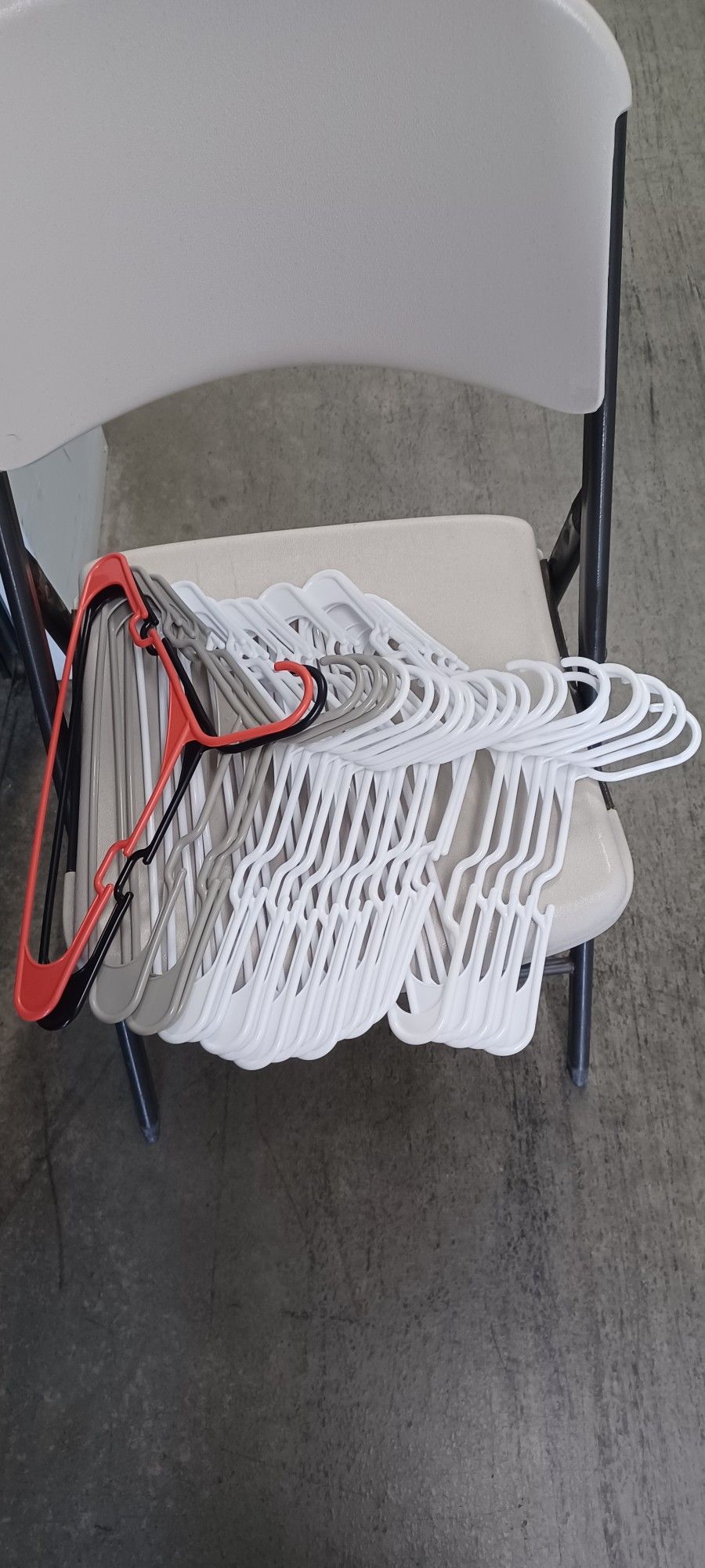 32 Mostly White Plastic Clothes Hangers.