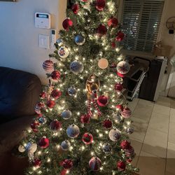 Christmas tree 6.5 feet. 100 ornaments Pre lighted