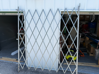 ULINE 5–6' x 7' Folding Security Gate – Galvanized Steel
