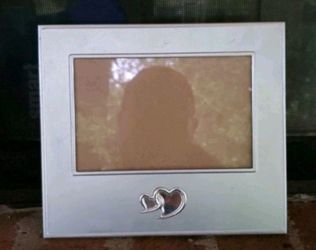 Chrome Picture Frame with Hearts on it