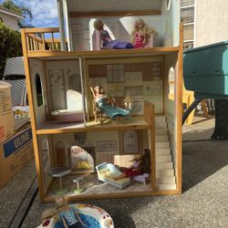 Dollhouse With Dolls, Barbies, And Furniture And Clothes