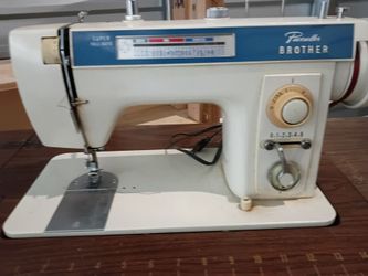 Vintage Brotherpacesetter 701 sewing machine and wooden cabinet that folds out