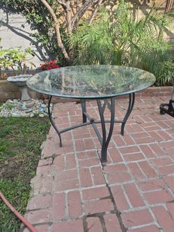 Glass Outdoor Table With Iron Base. 45 Inches Diameter. 29 Inches Tall
