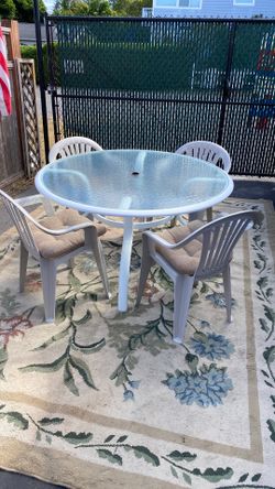 Glass top table and four chairs