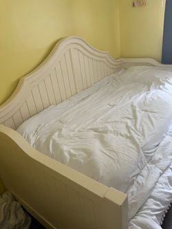 White wooden twin bed with trundle