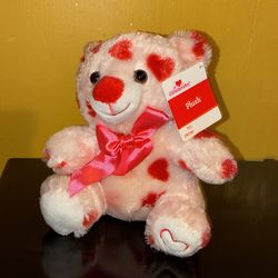 Pink teddy bear with red hearts