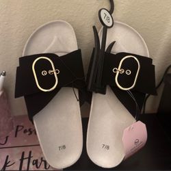 Black sandals with gold buckle