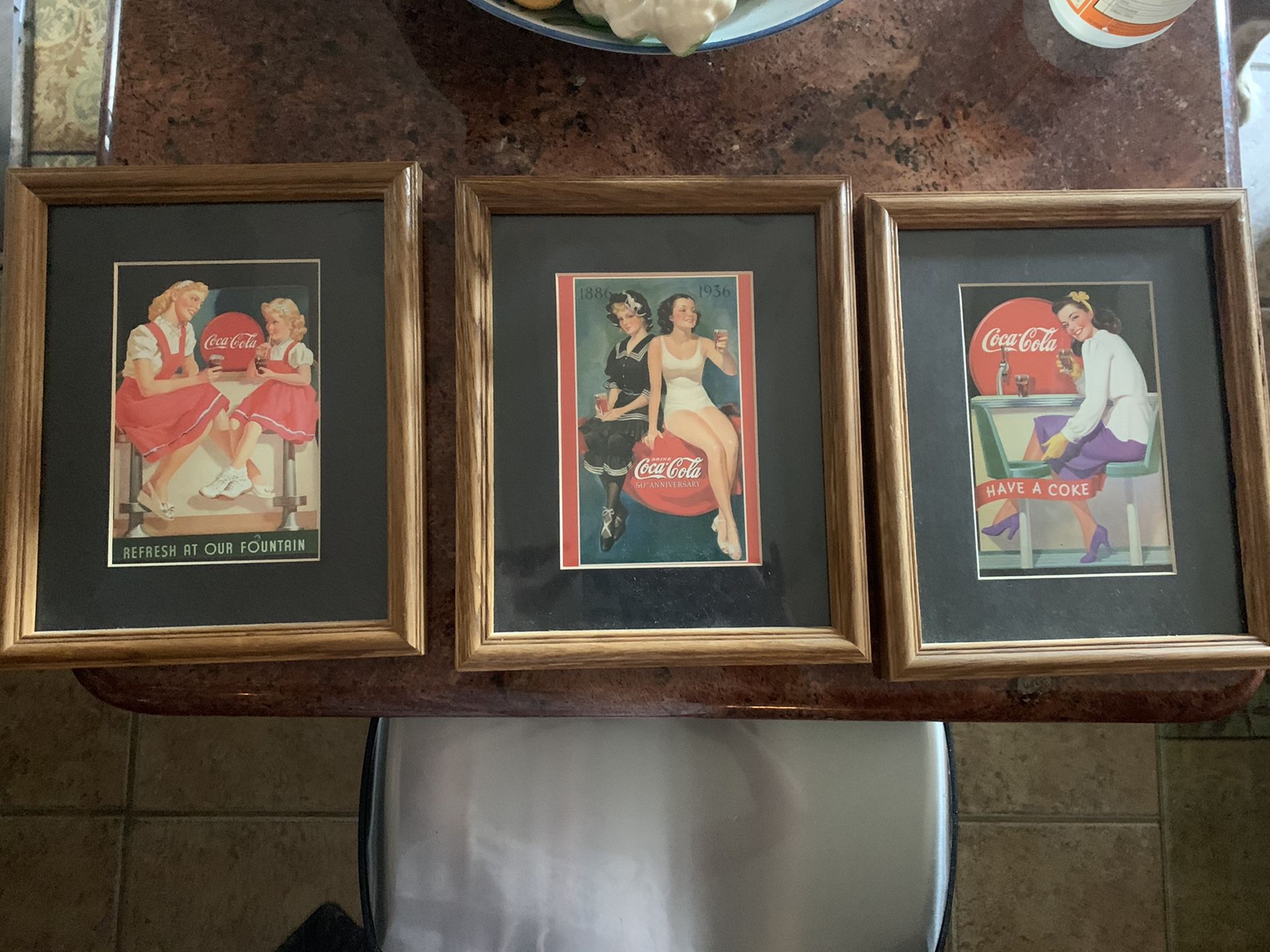 3 matted and framed Coca-Cola pictures