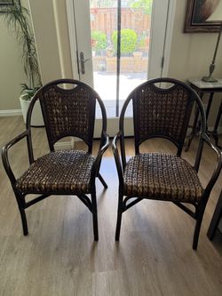 ebonized rattan and wicker armchairs