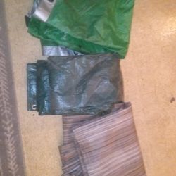 2 REGULAR PLASTIC/ POLYETHYLENE TARPS AND 1 MULTI MESH PVC TARP