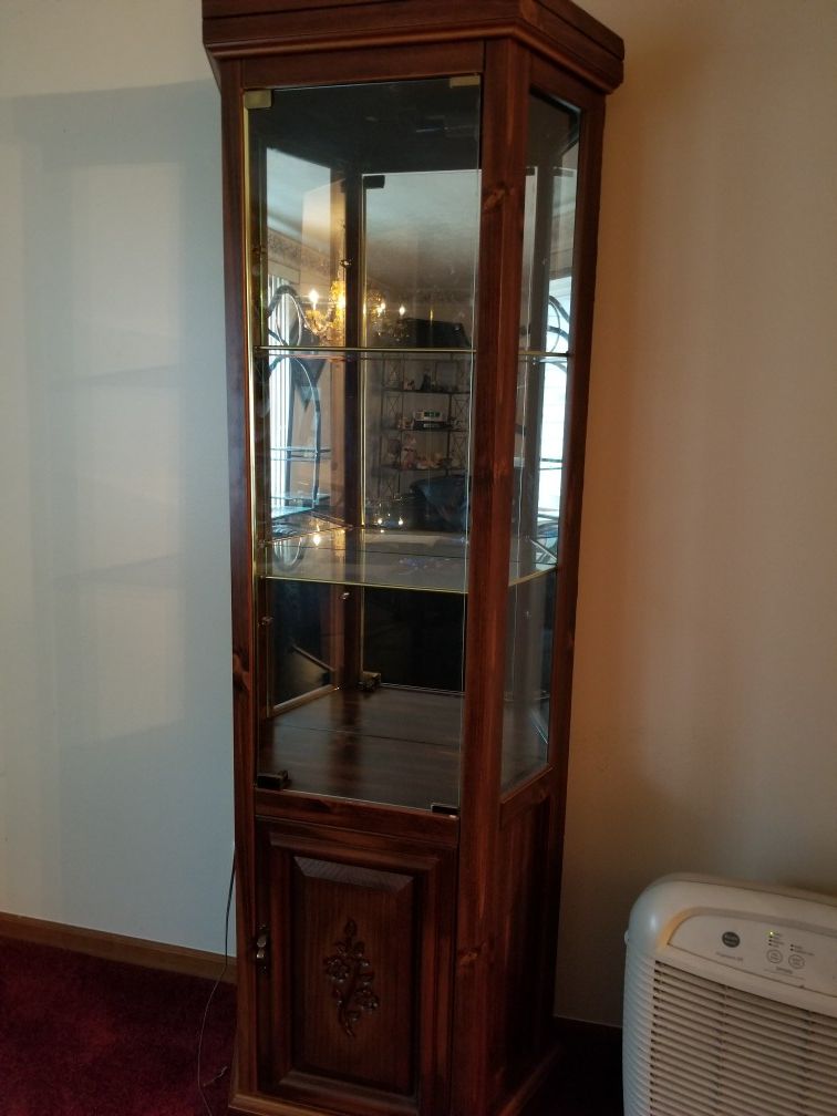 Lighted wood and glass curio cabinet
