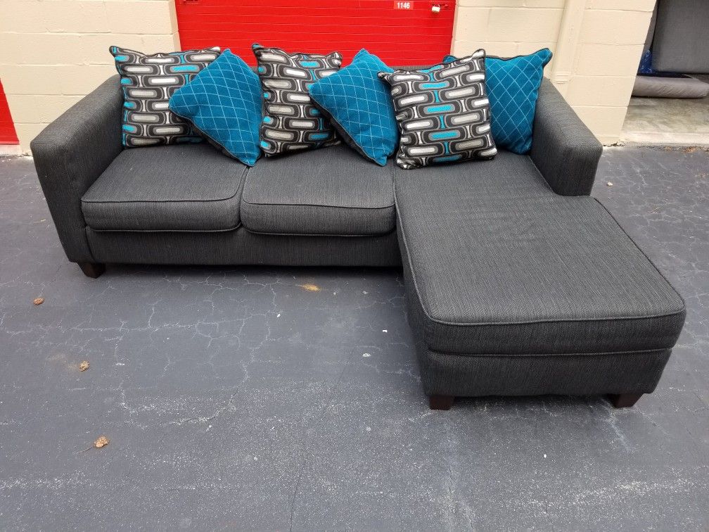 Nice Charcoal Gray Sectional w/ Grey and Blue Pillows