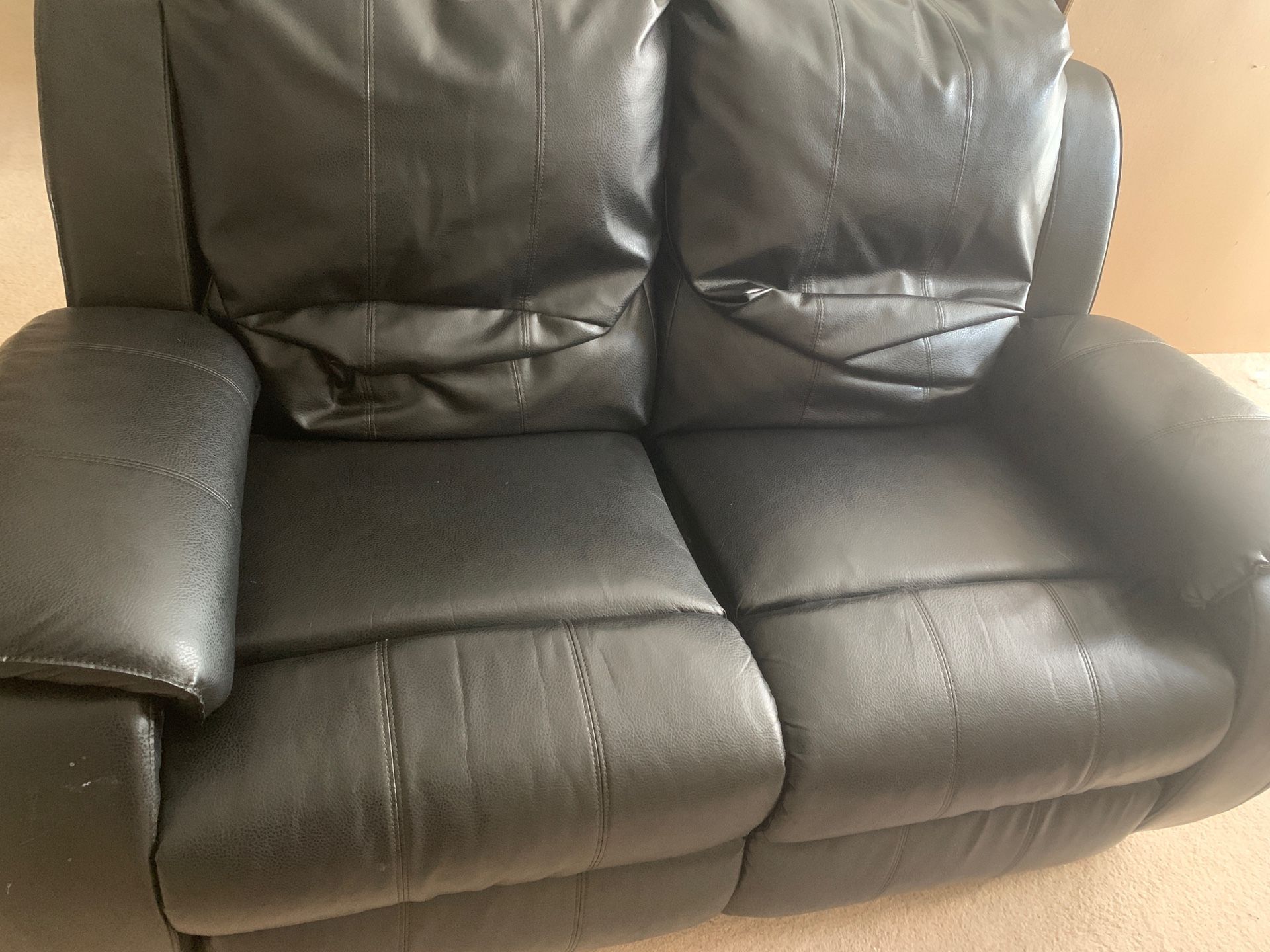Black leather reclining couch and loveseat