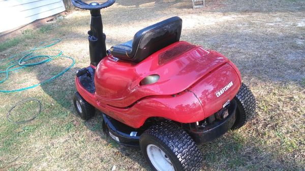 riding on lawn mower .her name is lady bug drm500