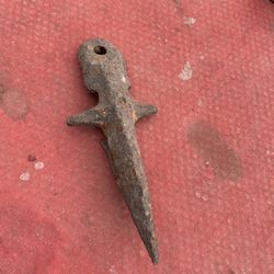 This is likely a finger from a sickle bar mower or combine harvester. These parts are used in farm machinery to divide and cut crops. 