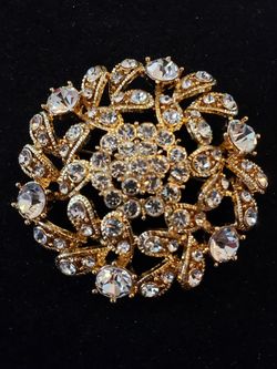 $10. Goldtone vintage and glass clear rhinestone flower starburst brooch. 2 inches in diameter.
